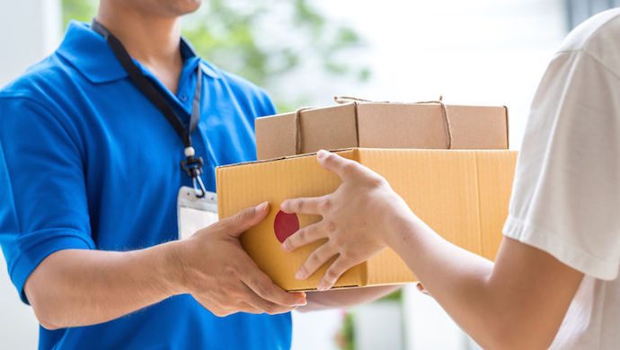 52450552 - woman hand accepting a delivery of boxes from deliveryman