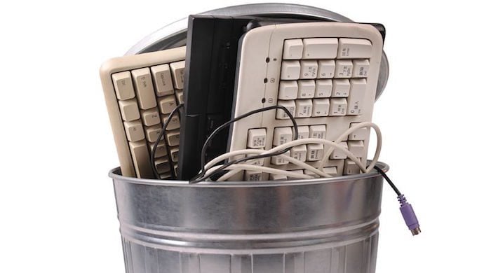 13851968 - different computer parts and phone in trash can