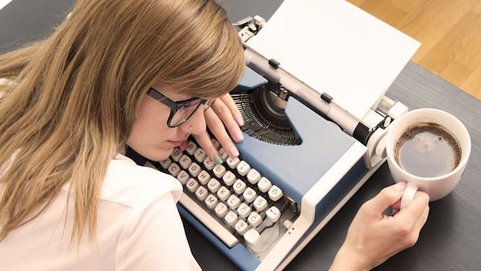 51369919 - tired writer sleeping on typewriter