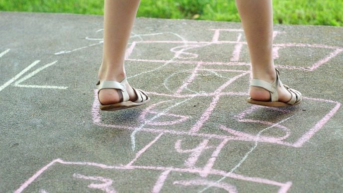 13565084 - girl playing hopscotch