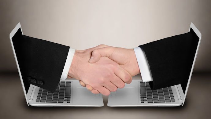 45898579 - business people handshake through computer