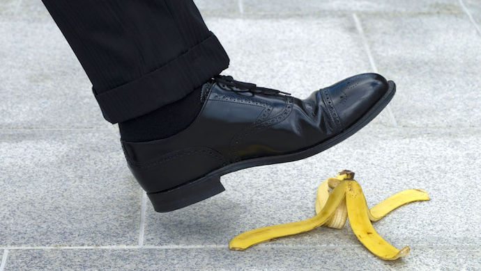 54148062 - businessman stepping on banana skin